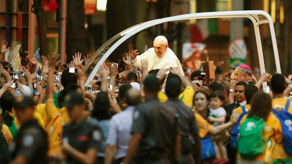 Pope Francis greets the crowd of faithful from his popemobile in downtown Rio de Janeiro.