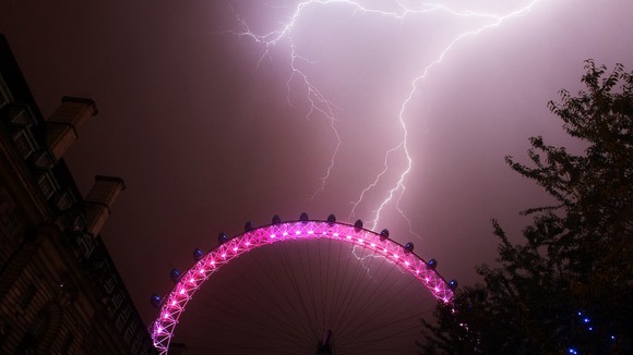 Lightning strikes behind the London Eye in central London.