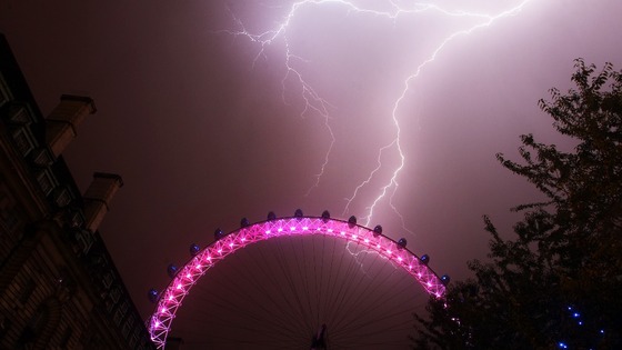 Lightning strikes behind the London Eye in central London.