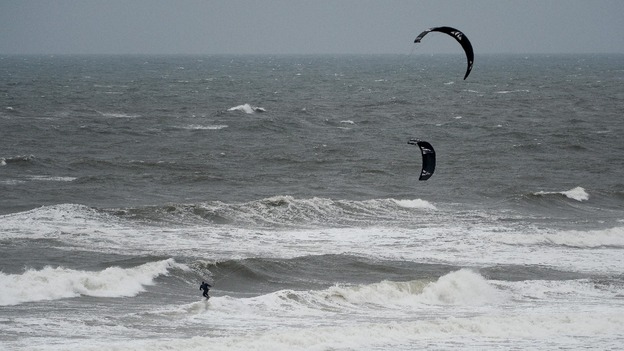 A kite surfer enjoys the strong winds on Tynemouth Beach, Tyne and Wear.
