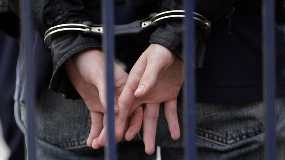 A man in handcuffs.