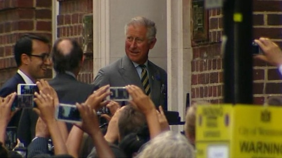 Prince Charles surrounded by cameras as he enters hospital.