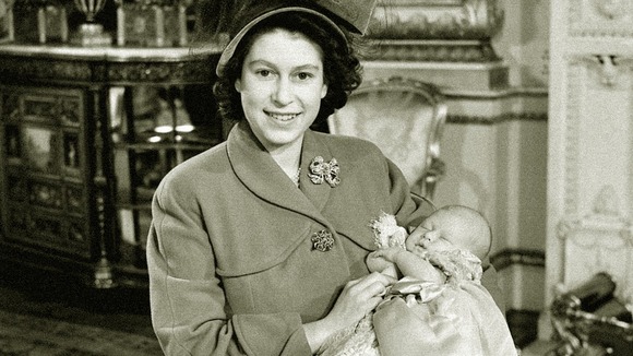Princess Elizabeth holds her baby son, Prince Charles after his christening in 1948.