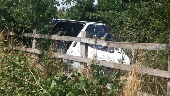 Minibus in a field after it crashed on the M3