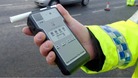 policeman holds breath test kit