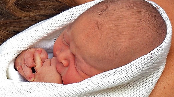 The new prince, in his mother's arms yesterday outside St Mary's Hospital.