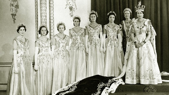 The Queen at Buckingham Palace with her maids of honour after her coronation in Westminster Abbey.