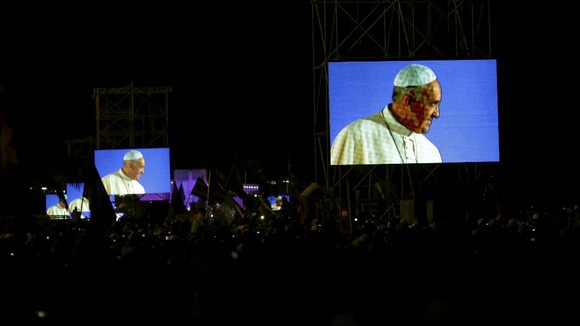 Pope Francis is projected on screens at Copacabana beach in Rio de Janeiro.