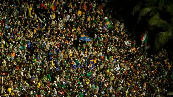 Catholic faithful throng the streets during the arrival of Pope Francis at Copacabana beach.