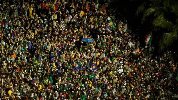 Catholic faithful throng the streets during the arrival of Pope Francis at Copacabana beach.