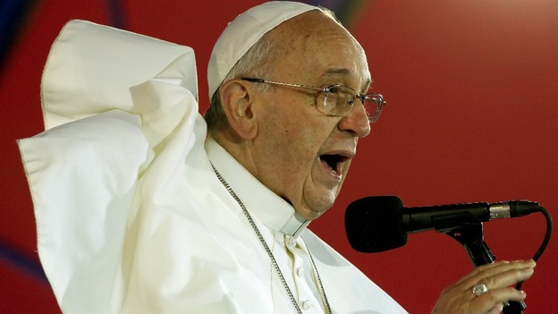 Pope Francis was battered by the wind and soaked with rain but continued to speak to the faithful on the beach.
