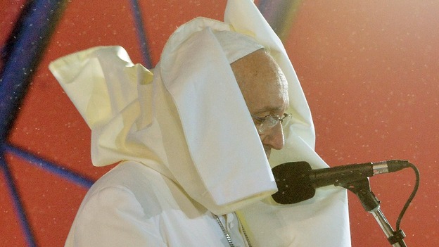 Pope Francis was battered by the wind and soaked with rain but continued to speak to the faithful on the beach.