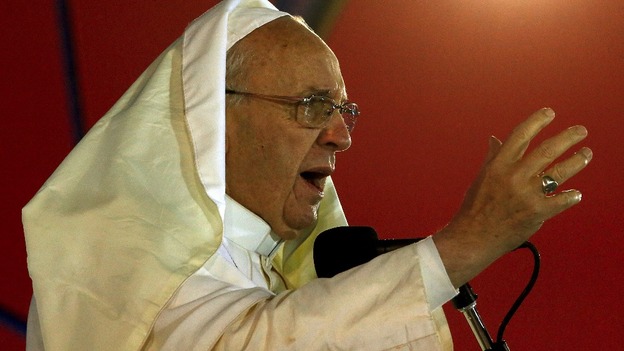 Pope Francis was battered by the wind and soaked with rain but continued to speak to the faithful on the beach.