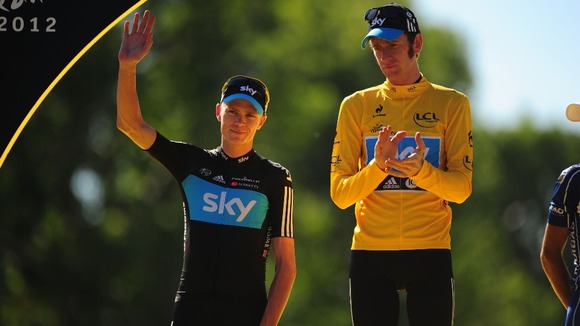 Wiggins with second placed rider and team mate, Froome as they stand on the winners podium at the end the 2012 event.