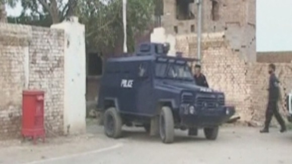 Pakistan police monitor the scene after the break in.