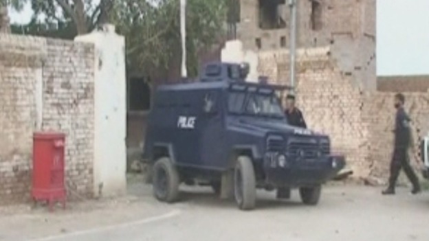 Pakistan police monitor the scene after the break in.