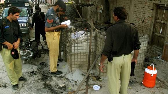 Policemen collect evidence today outside the prison.