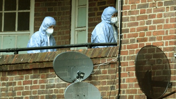 Forensic officers enter the scene where one of the attacks took place.