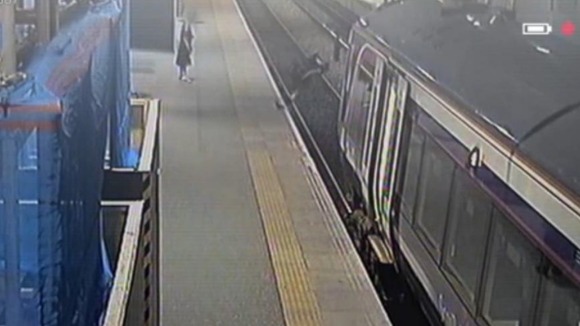 CCTV shows a man falling onto the track after trying to kick a pigeon on the platform.