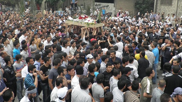 Anti-Syrian regime mourners carry the body of activist Nour al-Zahraa, 23, who was shot by Syrian security forces