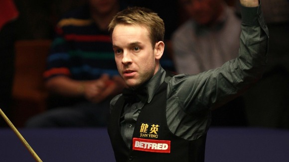 Ali Carter celebrates his victory over Judd Trump in the second round match during the Betfred.com World Snooker Championships at the Crucible Theatre, Sheffield.