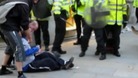 Ian Tomlinson can be seen on the ground during the G20 protests before his death.