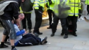 Ian Tomlinson can be seen on the ground during the G20 protests before his death.
