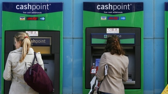 Women use a Lloyds ATM machine