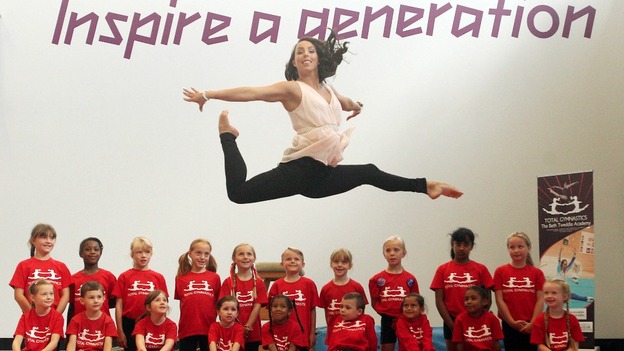 Beth Tweddle jumps above children from the Beth Tweddle Academy