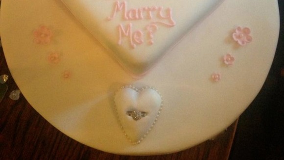 The heart-shaped cake was finished off with a plinth for the ring.