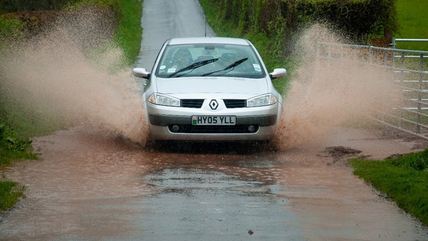 Car drives through water
