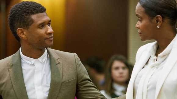 R&B singer Usher greets his ex-wife Tameka Foster after the hearing in Atlanta.