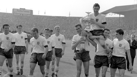 England's captain Johnny Haynes is held aloft by his team-mates after their emphatic win against Scotland