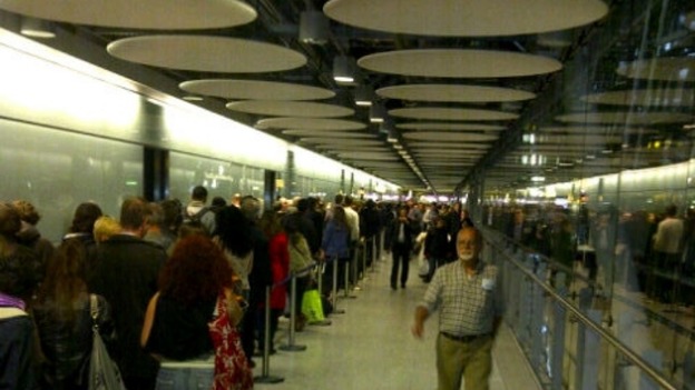 Passengers queue at Heathrow Airport