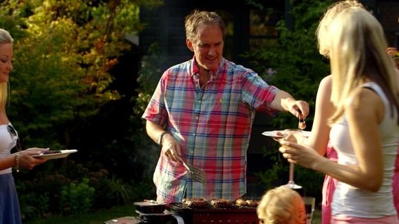 man serves meat at barbecue