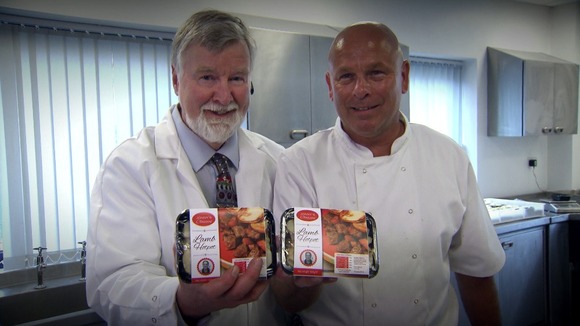 2 men hold up a ready meal