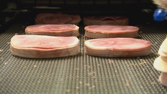 Sliced ham on conveyor belt