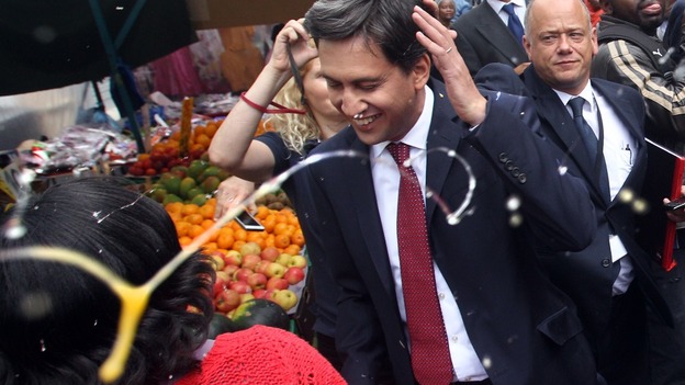 Ed Miliband is hit by an egg during a visit to a market in south London