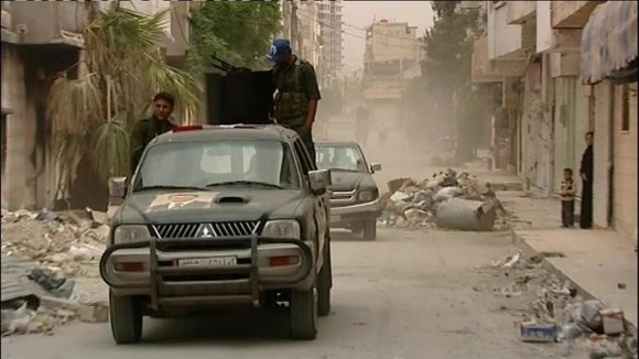 Pro-Assad forces patrol Syria's third largest city of Homs