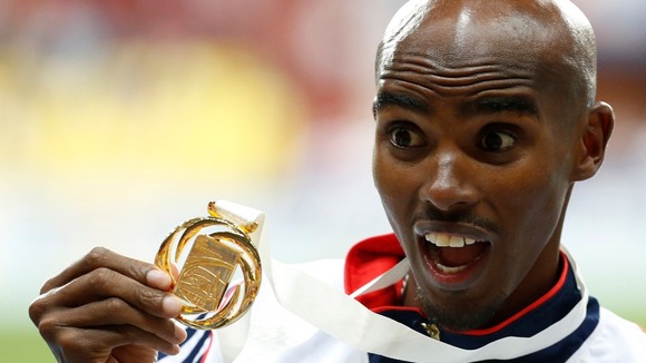 Mo Farah shows off his gold medal after winning the Men's 5,000m at the IAAF World Championships.