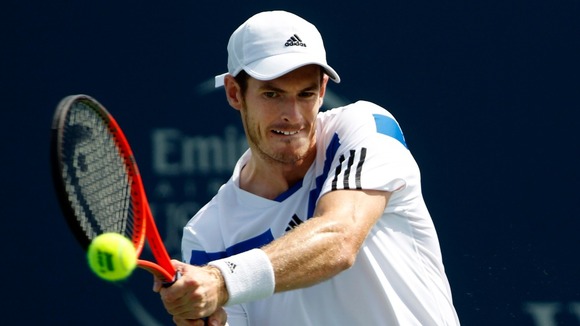 Andy Murray hits a return ball to Czech player Tomas Berdych.