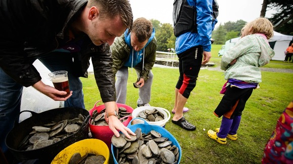 A competitor selects a stone to use during the National Stone Skimming Championship
