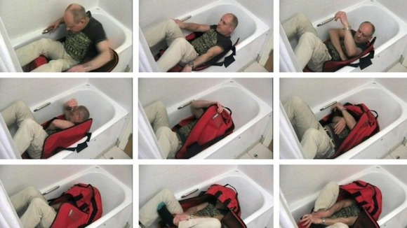 Images issued by the Metropolitan Police of a video reconstruction showing an "expert" trying to lock himself in a sports bag unaided.