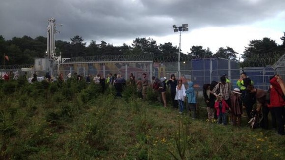 Protesters outside the perimeter fence of the test drilling site
