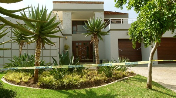 Police tape outside Oscar Pistorius' upmarket home where Reeva died