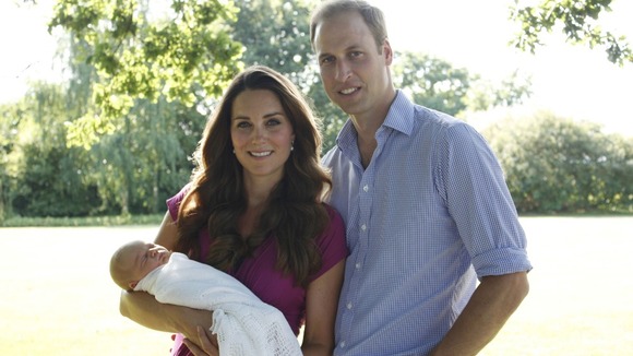 Prince George is held by his mother the Duchess of Cambridge.