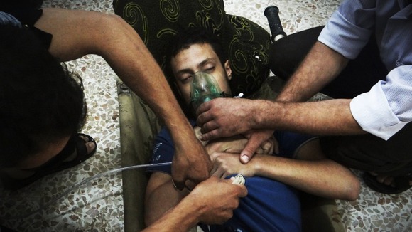 A man, allegedly affected by nerve gas, uses an oxygen mask to breathe in the Damascus suburbs of Jesreen