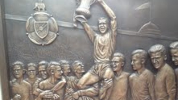 Relief on plinth of Nat Lofthouse memorial at Reekbok Stadium