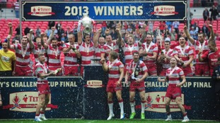 Wigan Warriors celebrate with the trophy after winning the Challenge Cup Final at Wembley Stadium, London.