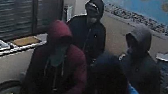 The four masked men pictured inside the Willenhall business premises